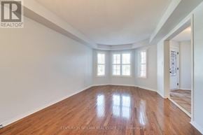 Mississauga (Lisgar) apartment for rent - A room with wooden floors and white walls, with a door on the right side.