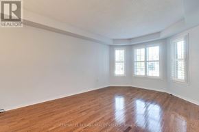 Mississauga (Lisgar) apartment for rent - A room with wooden floors and white walls.