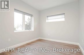Port Colborne (Main Street) townhouse for rent - A room with a window and a wooden floor.