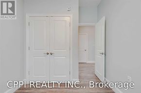 Port Colborne (Main Street) townhouse for rent - A white door with a handle and a small light on the wall above it.