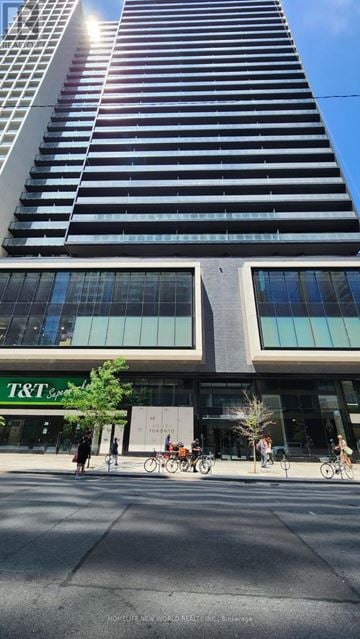 Toronto (Bay Street Corridor) condo for rent - A tall building with a T&T bank branch in front.