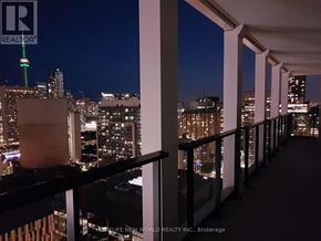 Toronto (Bay Street Corridor) condo for rent - A balcony overlooks a city at night.