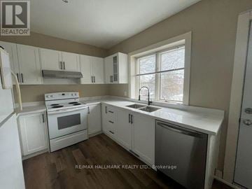 Toronto (South Riverdale) apartment for rent - A kitchen with white cabinets and appliances is for sale.