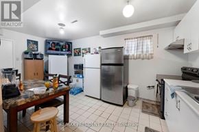 Mississauga (Malton) apartment for rent - A kitchen with a refrigerator, stove, and sink.
