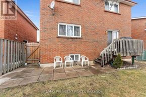 Mississauga (Malton) apartment for rent - A red brick house with a patio and chairs.