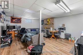 Mississauga (Malton) apartment for rent - A room with a couch, a chair, a desk, and a TV.