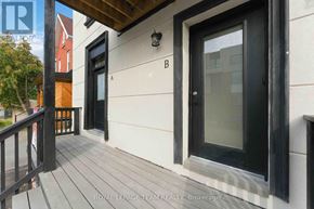 Ottawa triplex for rent - A balcony with a black railing and a glass door.