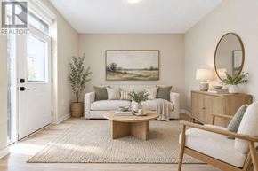 Ottawa triplex for rent - A living room with a white couch, a coffee table, and a painting on the wall.