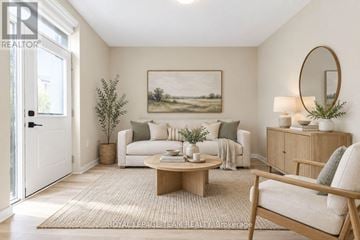 Ottawa triplex for rent - A living room with a white couch, a coffee table, and a painting on the wall.