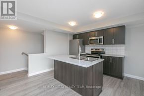 Ottawa condo for rent - A modern kitchen with a sink, stove, and microwave.