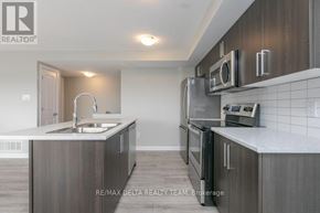 Ottawa condo for rent - A modern kitchen with a sink, stove, and oven.