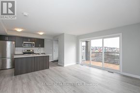 Ottawa condo for rent - A spacious kitchen with stainless steel appliances and a view of the outdoors.