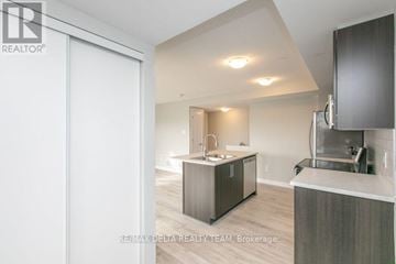 Ottawa condo for rent - A modern kitchen with a sink and a refrigerator.