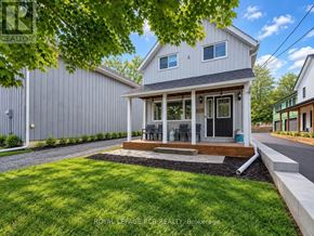 King (Schomberg) apartment for rent - A house with a grey exterior and a covered patio.
