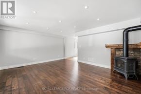 King (Schomberg) apartment for rent - A wood burning stove in a large empty room.