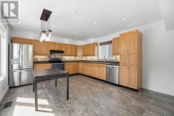 King (Schomberg) apartment for rent - A modern kitchen with wooden cabinets and a central island.