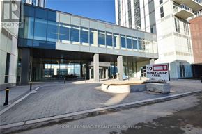Vaughan (Vaughan Corporate Centre) condo for rent - A modern building with a glass facade and a sign that reads "10 HONEYCRISP CRES.".