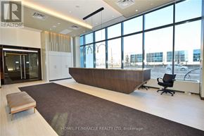 Vaughan (Vaughan Corporate Centre) condo for rent - A reception area with a brown bench and a black chair.