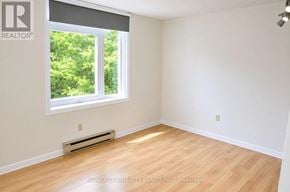 London South (South J) condo for rent - A room with a window and a wall-mounted air conditioner.