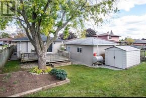 Cambridge apartment for rent - A backyard with a tree, a shed, and a wooden deck.