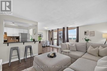 London East (East K) condo for rent - A living room with a grey couch and a coffee table.