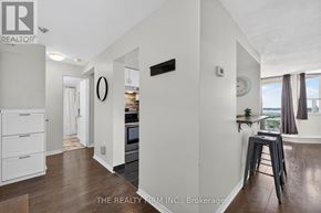 London East (East K) condo for rent - A well-lit kitchen with a bar stool and a clock on the wall.