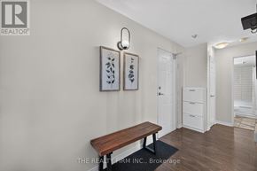 London East (East K) condo for rent - A room with a bench, two pictures and a door.