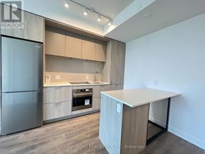 Toronto (Regent Park) condo for rent - A modern kitchen with a refrigerator, oven, and countertop.