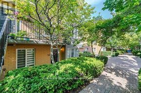 Toronto (Niagara) townhouse for rent - A tree-lined walkway leads to a building with the number 53 on it.