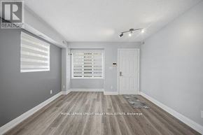 Toronto (Niagara) townhouse for rent - A room with a white door and a window with blinds.