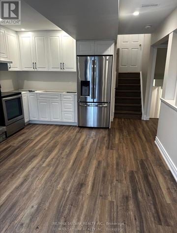 Waterloo apartment for rent - A kitchen with white cabinets and a stainless steel refrigerator.