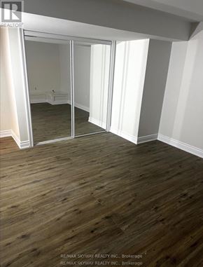 Waterloo apartment for rent - A room with wooden floors and a large mirror.