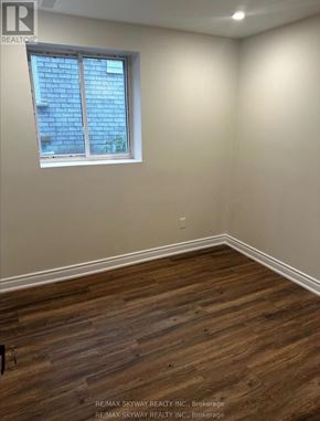 Waterloo apartment for rent - A room with a window and wooden flooring.