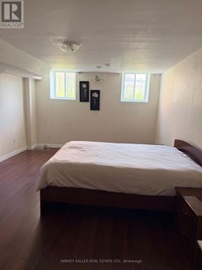 Toronto (Rouge) apartment for rent - A bedroom with a bed, nightstands, and two windows.