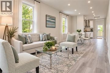 Hamilton apartment for rent - A well-lit living room with a glass coffee table and a grey sofa.