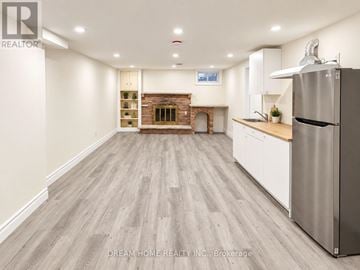 Toronto (L'amoreaux) apartment for rent - A kitchen with a refrigerator on the right side.