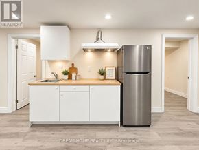 Toronto (L'amoreaux) apartment for rent - A modern kitchen with white cabinets and a stainless steel refrigerator.