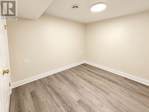 Toronto (L'amoreaux) apartment for rent - A room with wooden flooring and a white door.