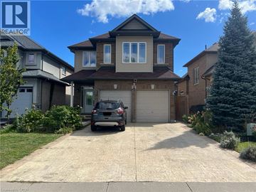 Hamilton apartment for rent - A house with a garage and a car parked in front.