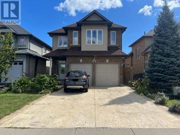 Hamilton apartment for rent - A house with a garage and a car parked in front.