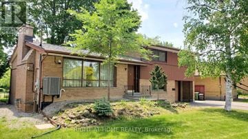 Toronto (Willowdale West) apartment for rent - A house with a red brick exterior and a large front yard.