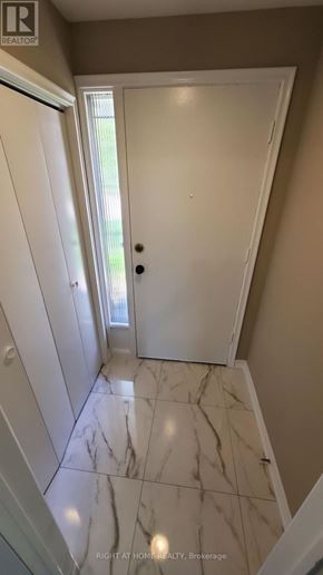 Toronto (Willowdale West) apartment for rent - A hallway with marble flooring and white doors.