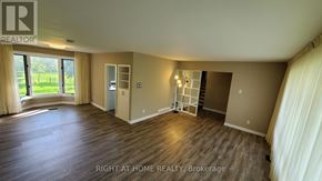 Toronto (Willowdale West) apartment for rent - A spacious room with wooden flooring and a large window with curtains.