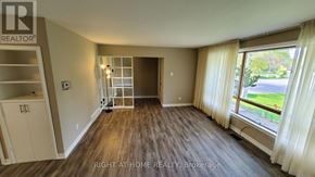 Toronto (Willowdale West) apartment for rent - A room with a wooden floor and a large window with curtains.