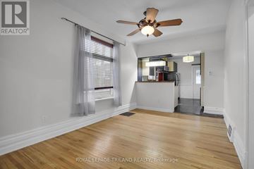 London South (South F) apartment for rent - A room with a ceiling fan and wooden flooring.