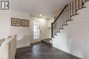 Quinte West (Trenton Ward) apartment for rent - A white hallway with a staircase and two pictures on the wall.