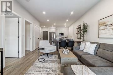 Central Elgin (Port Stanley) multi-family for rent - A well-lit, modern living room with a grey sofa and a coffee table.