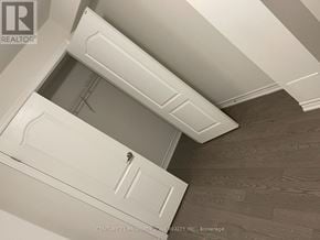 Brampton (Credit Valley) apartment for rent - A white door with a handle is in the middle of a room with a wooden floor.
