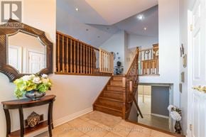 Niagara Falls (Ascot) apartment for rent - A foyer with a staircase and a mirror on the wall.