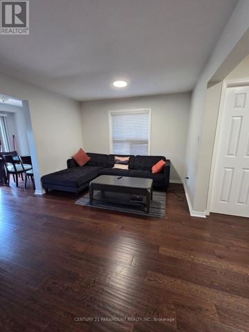 Mississauga (Meadowvale Village) townhouse for rent - A living room with a black couch and a coffee table.